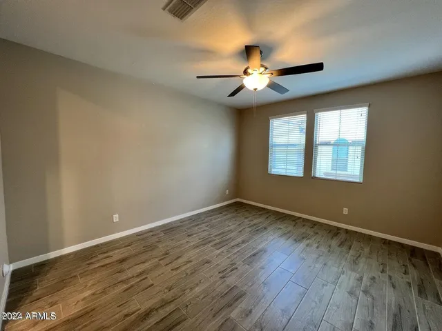 a bathroom with a granite countertop double vanity sink and a mirror