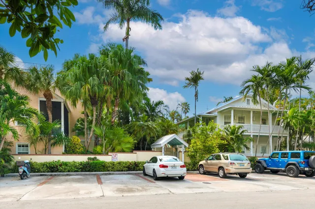 a car parked in front of a house with a street
