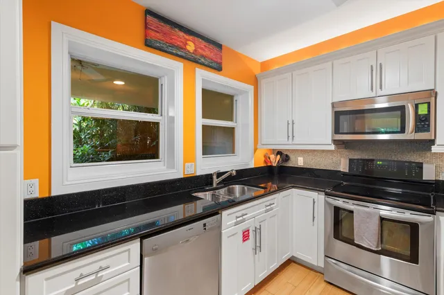 a kitchen with granite countertop cabinets and steel stainless steel appliances
