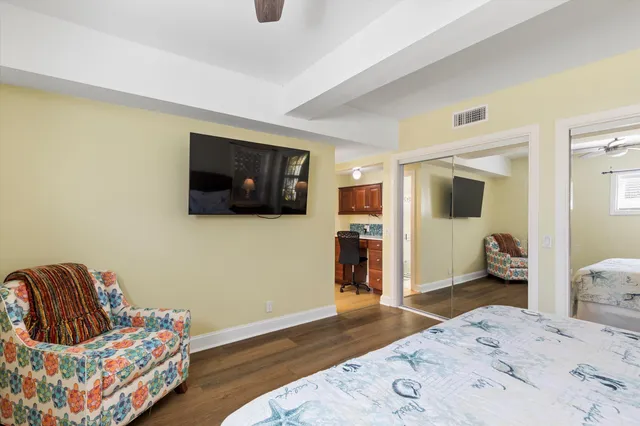 a spacious bedroom with a bed and a dresser