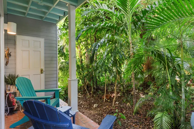 a view of a patio with couches table and chairs and potted plants