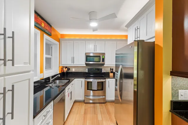 a kitchen that has a sink and a stove