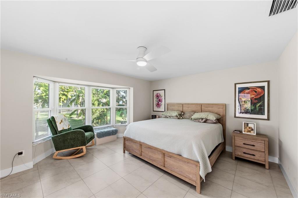 4724 Riverside Drive Estero, FL 33928 - Photo 14 of 44 a bedroom with a bed and a couch