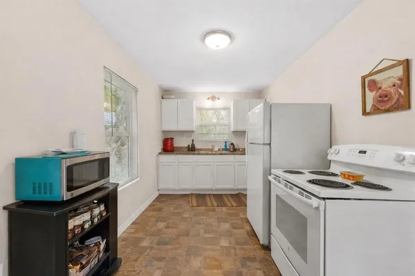 a kitchen with stainless steel appliances a refrigerator stove and sink