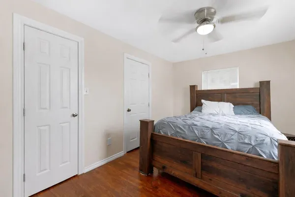 a bedroom with a bed and a chandelier