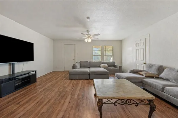 a living room with furniture and a flat screen tv
