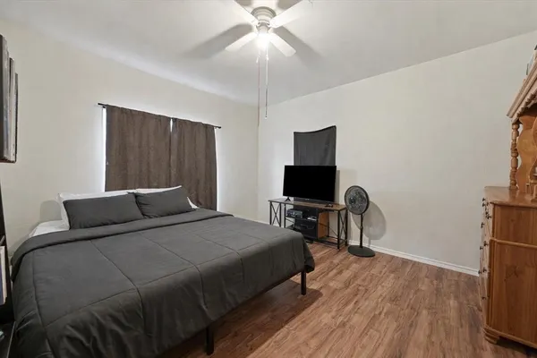 a bedroom with a bed and a flat screen tv