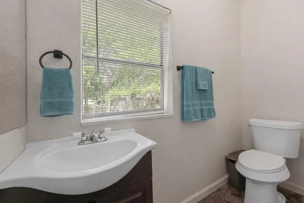 a bathroom with a sink toilet and a mirror