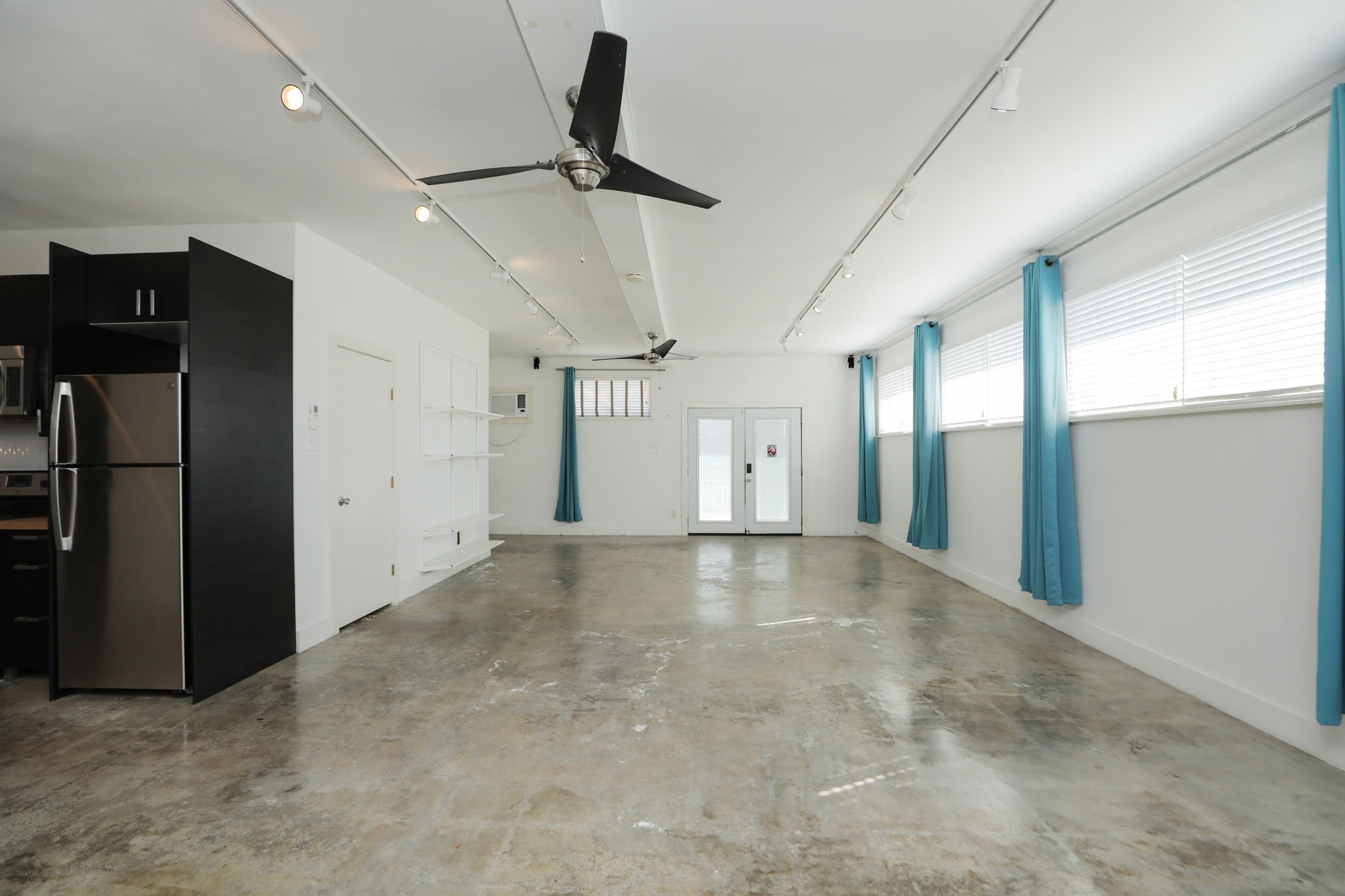 2215 Cleburne Street Houston, TX 77004 - Photo 12 of 21 a view of a livingroom with a refrigerator ceiling fan and window