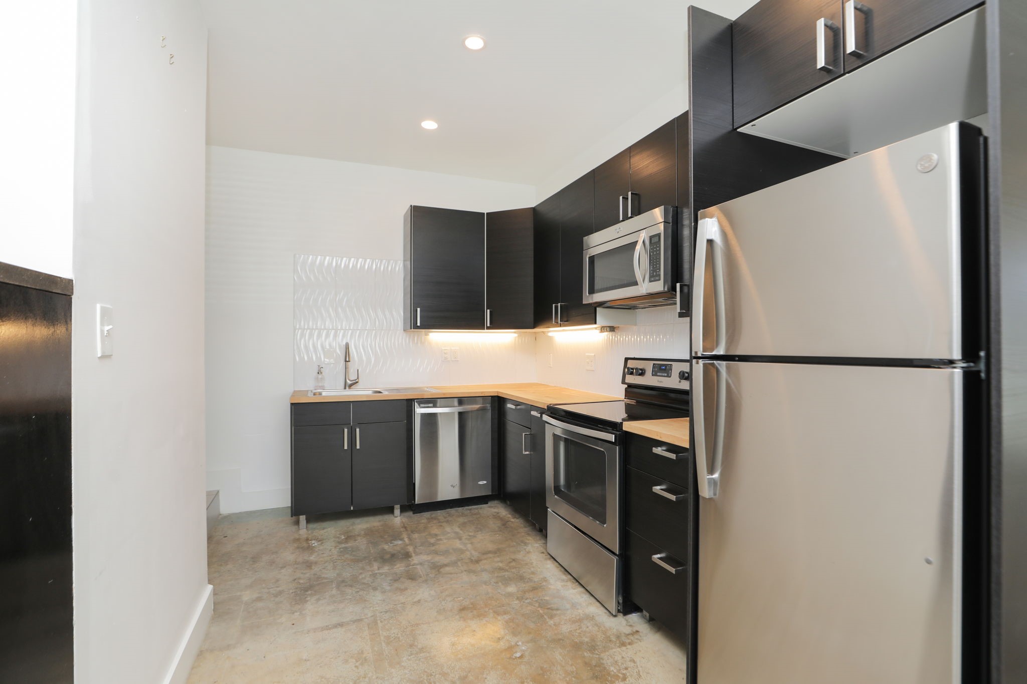 2215 Cleburne Street Houston, TX 77004 - Photo 15 of 21 a kitchen with stainless steel appliances granite countertop a refrigerator and a sink