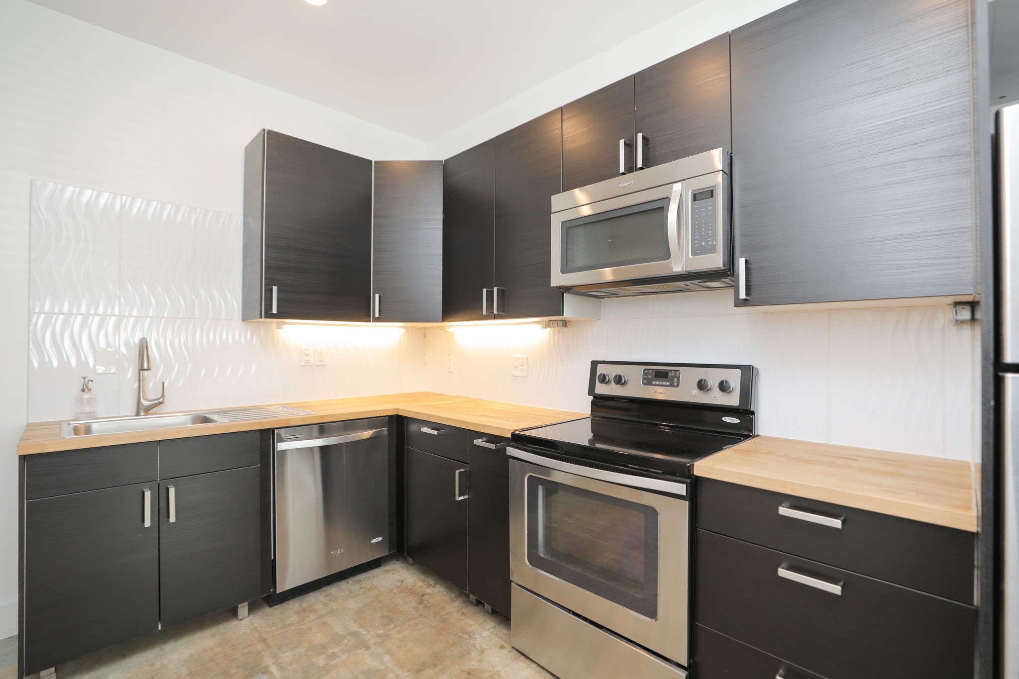 2215 Cleburne Street Houston, TX 77004 - Photo 16 of 21 a kitchen with stainless steel appliances a stove sink and microwave
