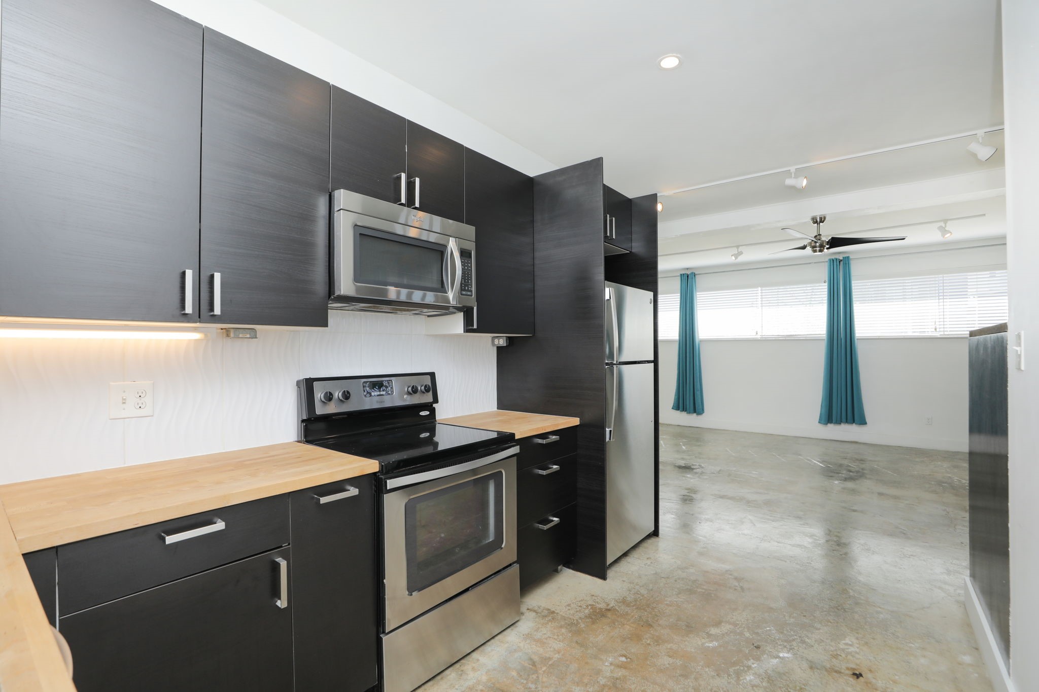 2215 Cleburne Street Houston, TX 77004 - Photo 17 of 21 a kitchen with stainless steel appliances granite countertop a refrigerator and a stove top oven