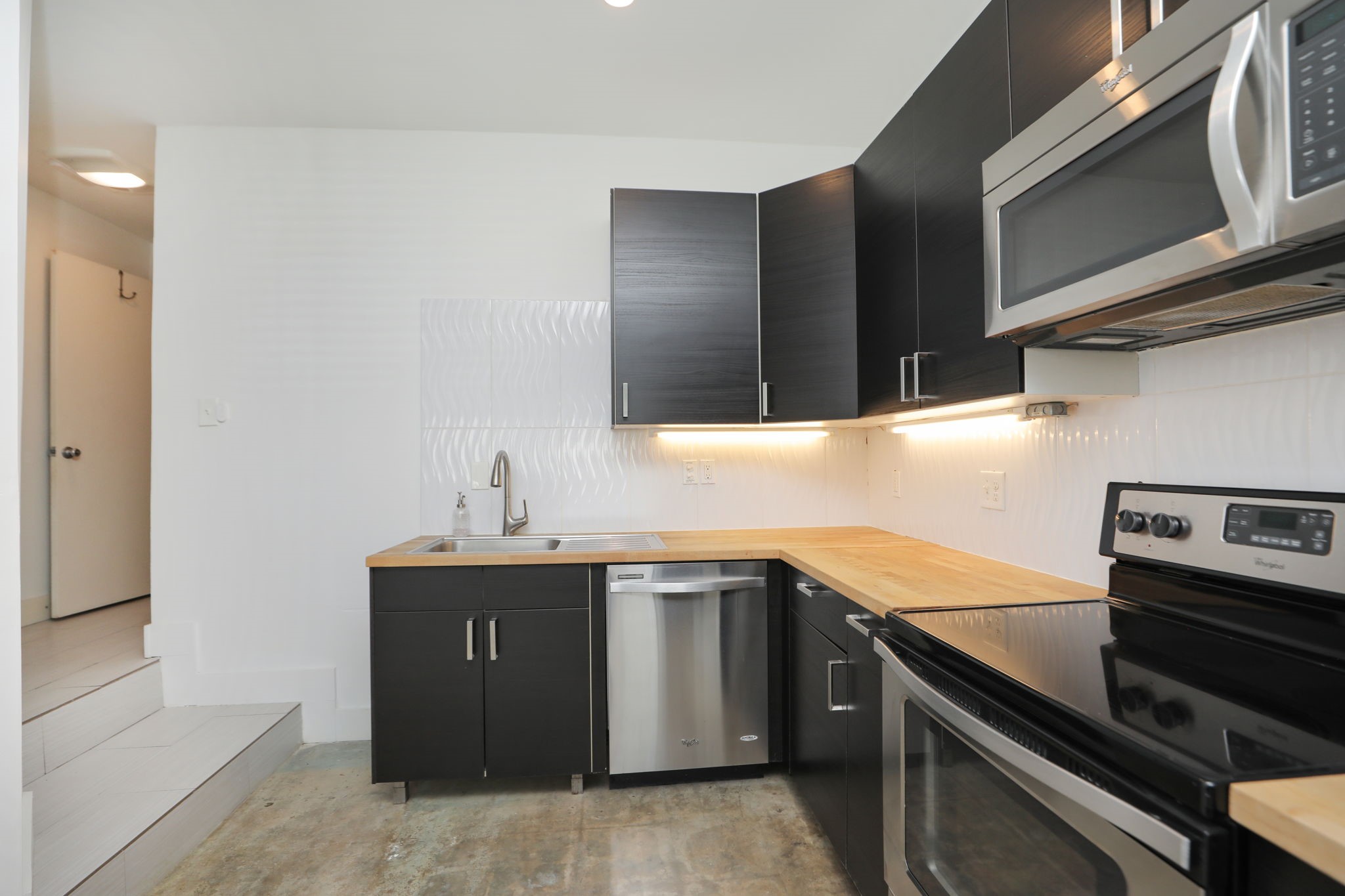 2215 Cleburne Street Houston, TX 77004 - Photo 18 of 21 a kitchen with stainless steel appliances a sink stove and cabinets