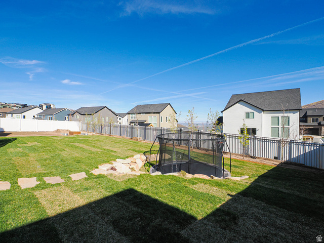 2487 Canyon Wild Road, Unit 413 Draper, UT 84020 - Photo 60 of 75 Fenced backyard featuring a residential view and a trampoline