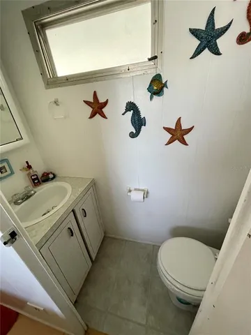 a bathroom with a sink mirror vanity and toilet