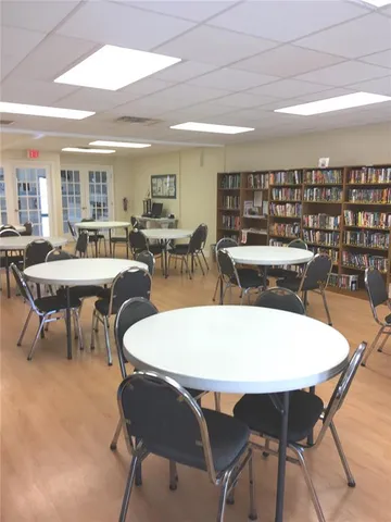 a view of a dining room with furniture and window