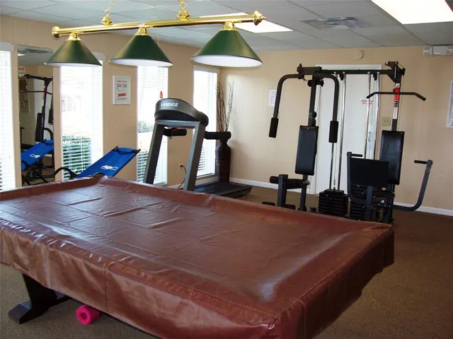 a room with gym equipment and a mirror