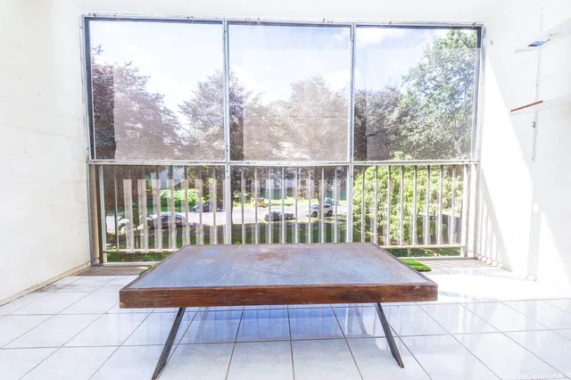 a view of a room with a balcony and furniture