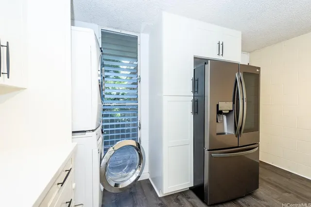 a metallic refrigerator freezer sitting in a kitchen
