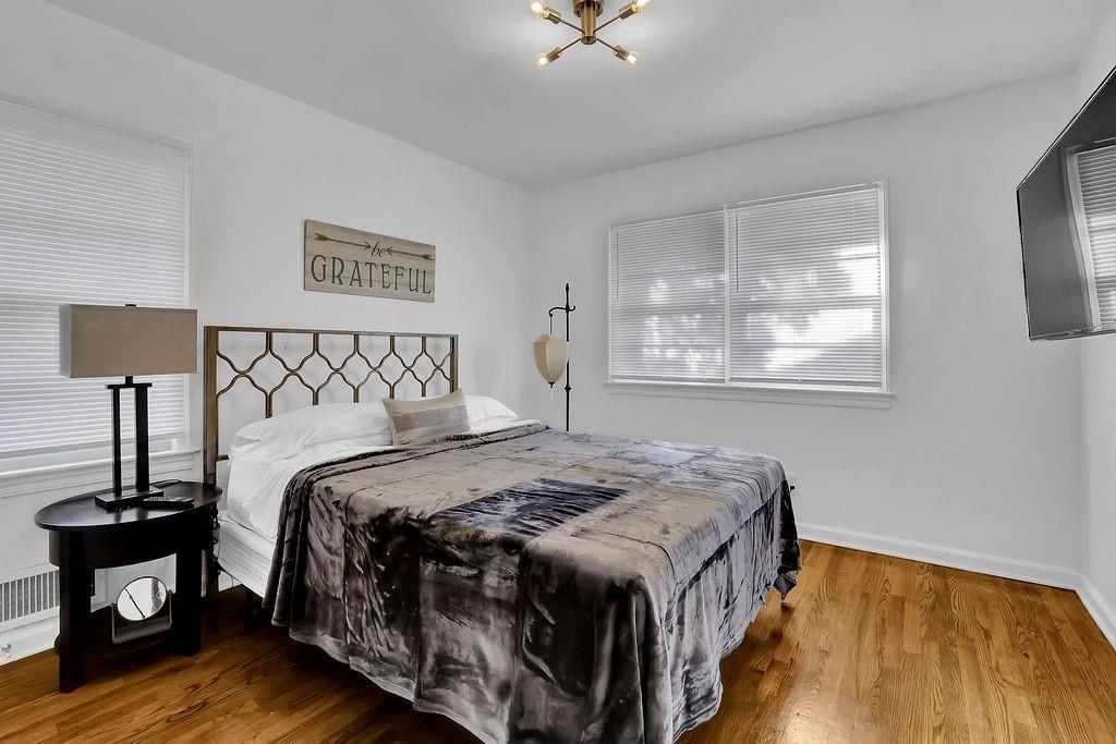 1124 Longshore Drive Decatur, GA 30032 - Photo 12 of 18 a bedroom with a bed and wooden floor