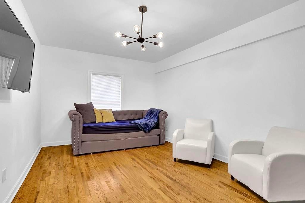 1124 Longshore Drive Decatur, GA 30032 - Photo 16 of 18 a living room with furniture and a wooden floor