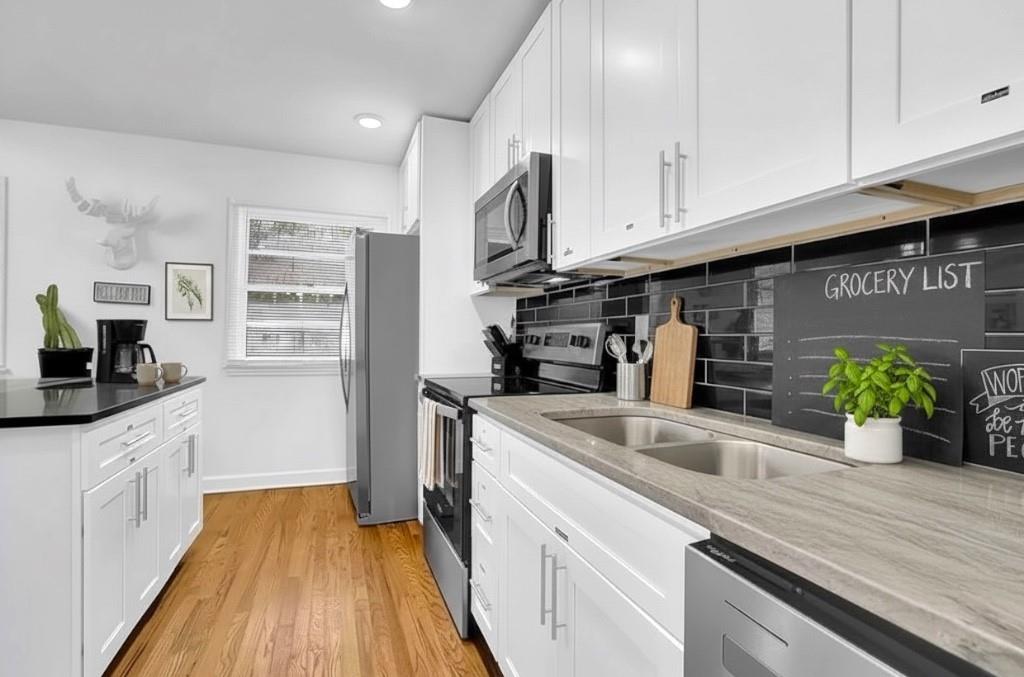 1124 Longshore Drive Decatur, GA 30032 - Photo 6 of 18 a kitchen with stainless steel appliances granite countertop a sink a stove and cabinets