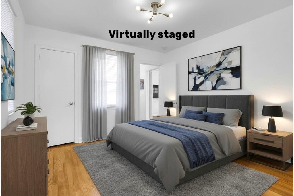 1124 Longshore Drive Decatur, GA 30032 - Photo 8 of 18 a spacious bedroom with a bed and a chandelier