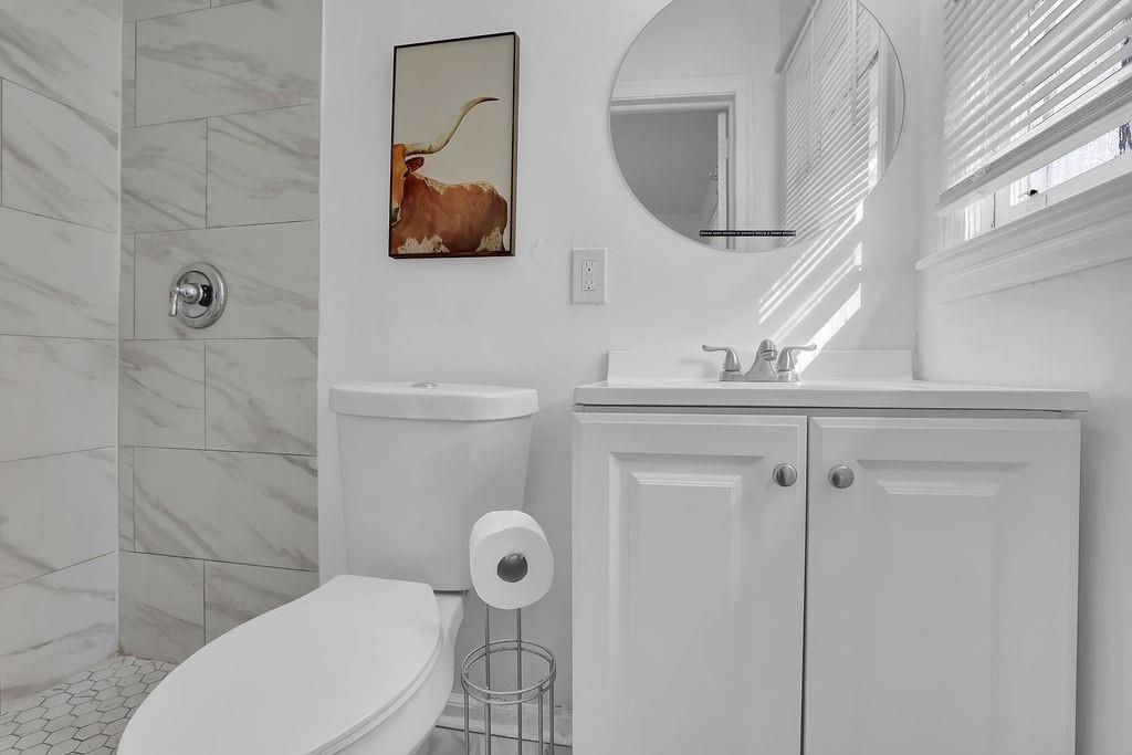 1124 Longshore Drive Decatur, GA 30032 - Photo 9 of 18 a bathroom with a toilet sink and mirror