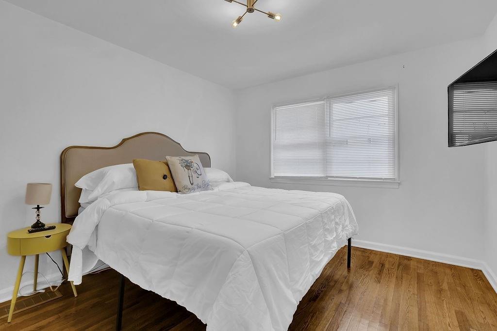 1124 Longshore Drive Decatur, GA 30032 - Photo 10 of 18 a bedroom with a bed and wooden floor