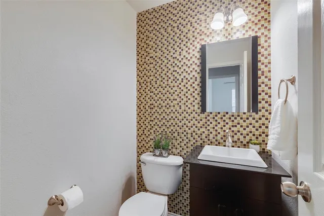 a view of an empty room with a fireplace and chandelier fan