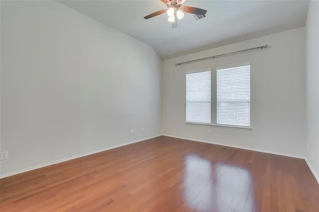 a view of kitchen with refrigerator and wooden floor