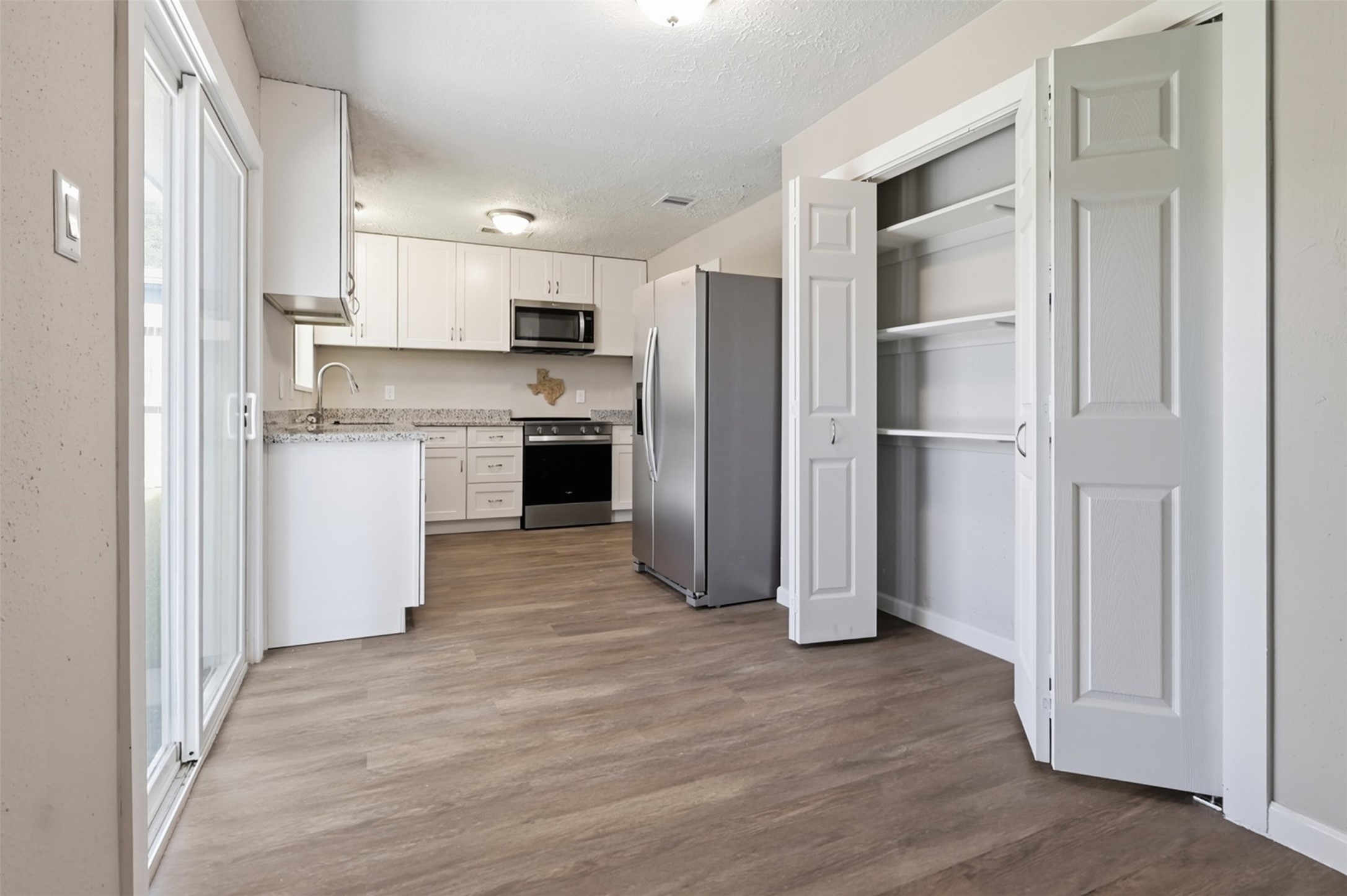 4767 Beechaven Street Houston, TX 77053 - Photo 13 of 26 a kitchen with stainless steel appliances granite countertop a refrigerator and a stove top oven