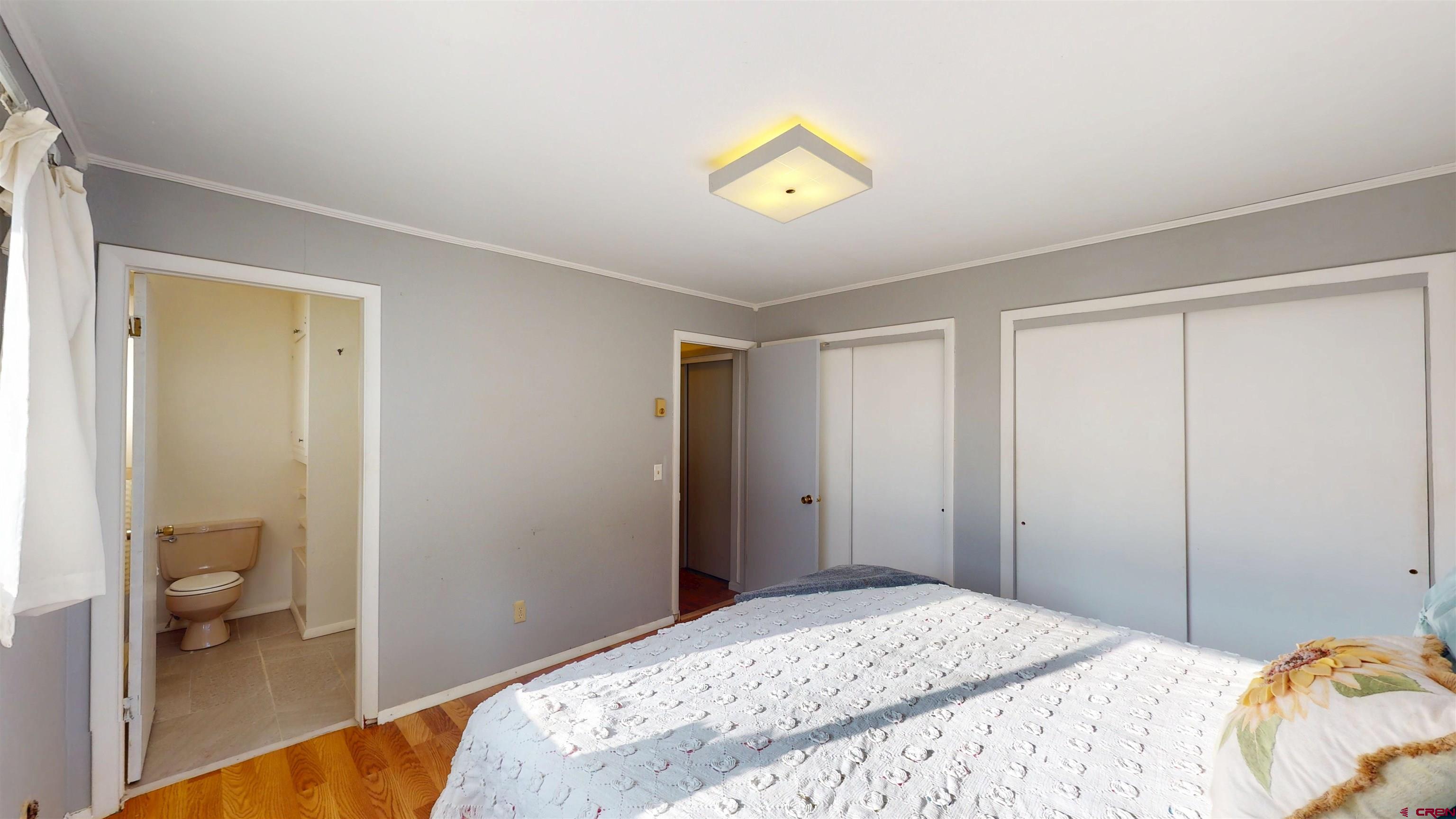 205 Southeast Frontier Avenue Cedaredge, CO 81413 - Photo 2 of 41 a bedroom with a bed and a view of bathroom