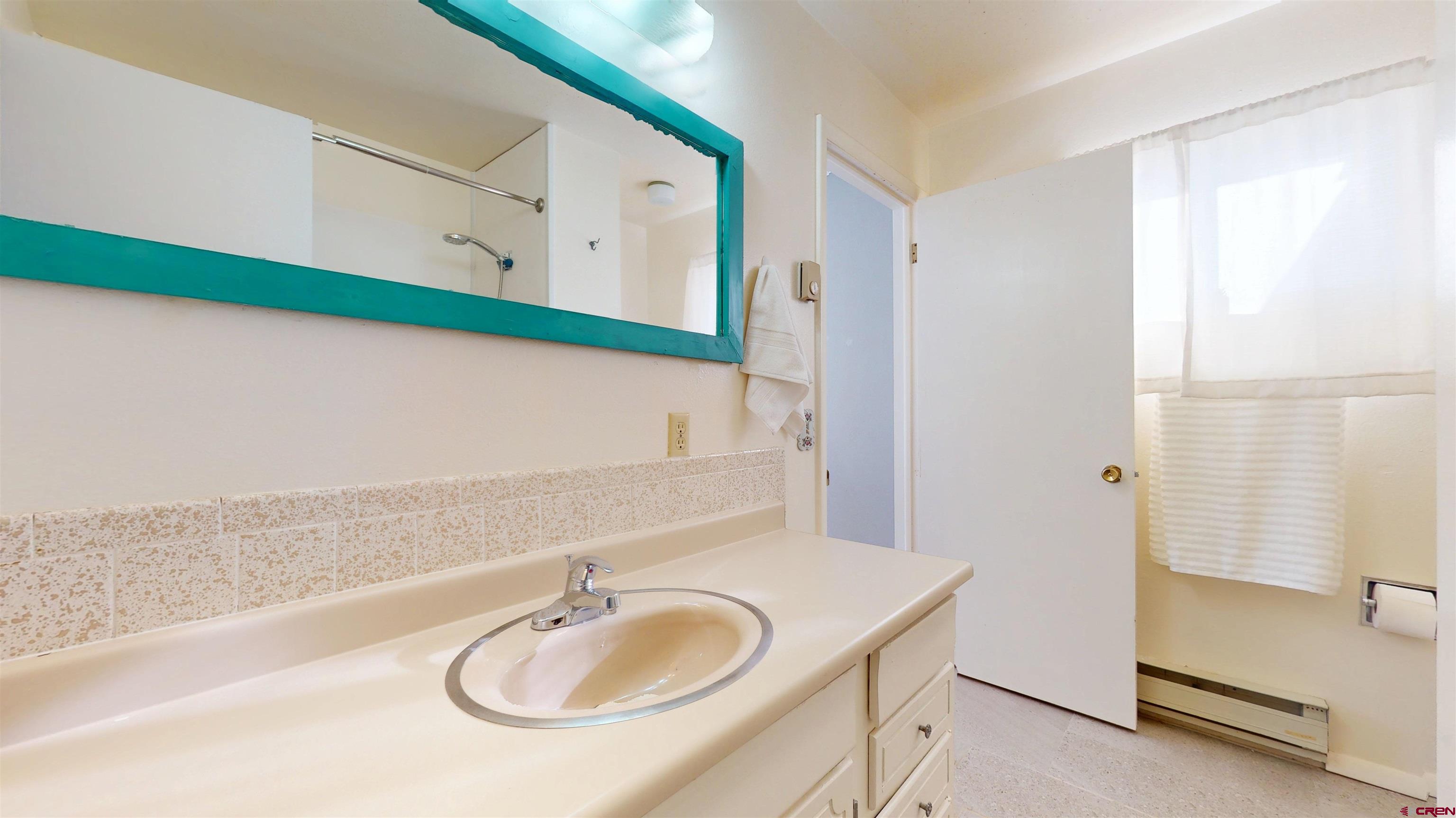 205 Southeast Frontier Avenue Cedaredge, CO 81413 - Photo 27 of 41 a bathroom with a sink and a mirror