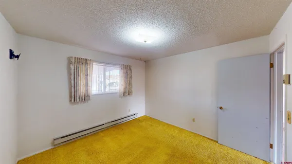 a living room with stainless steel appliances kitchen island granite countertop furniture a rug kitchen view and a chandelier