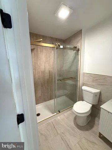 a bathroom with a toilet and a shower