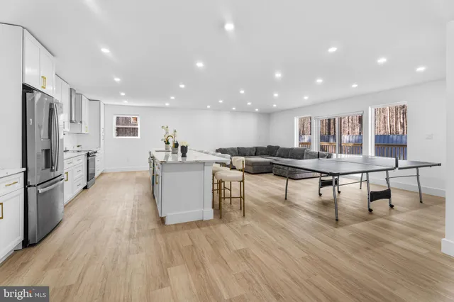 a dining room with furniture and wooden floor