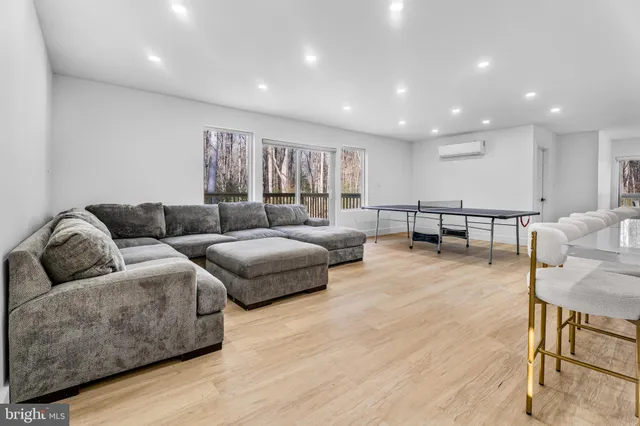 a living room with a bed furniture and a window