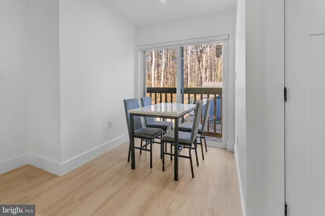 a white toilet sitting next to a white cabinet