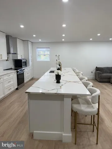 a kitchen with a stove a refrigerator and a dining table