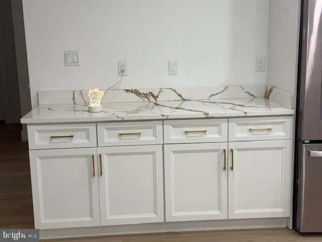 a view of a sink with wooden cabinets