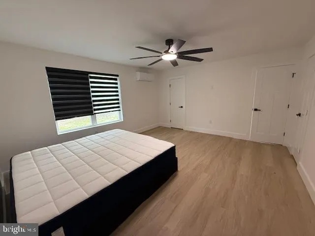 a room with a bed and a ceiling fan