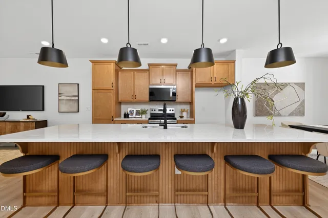a kitchen with a counter space chairs and cabinets