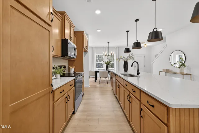 a kitchen with kitchen island granite countertop lots of counter top space and stainless steel appliances
