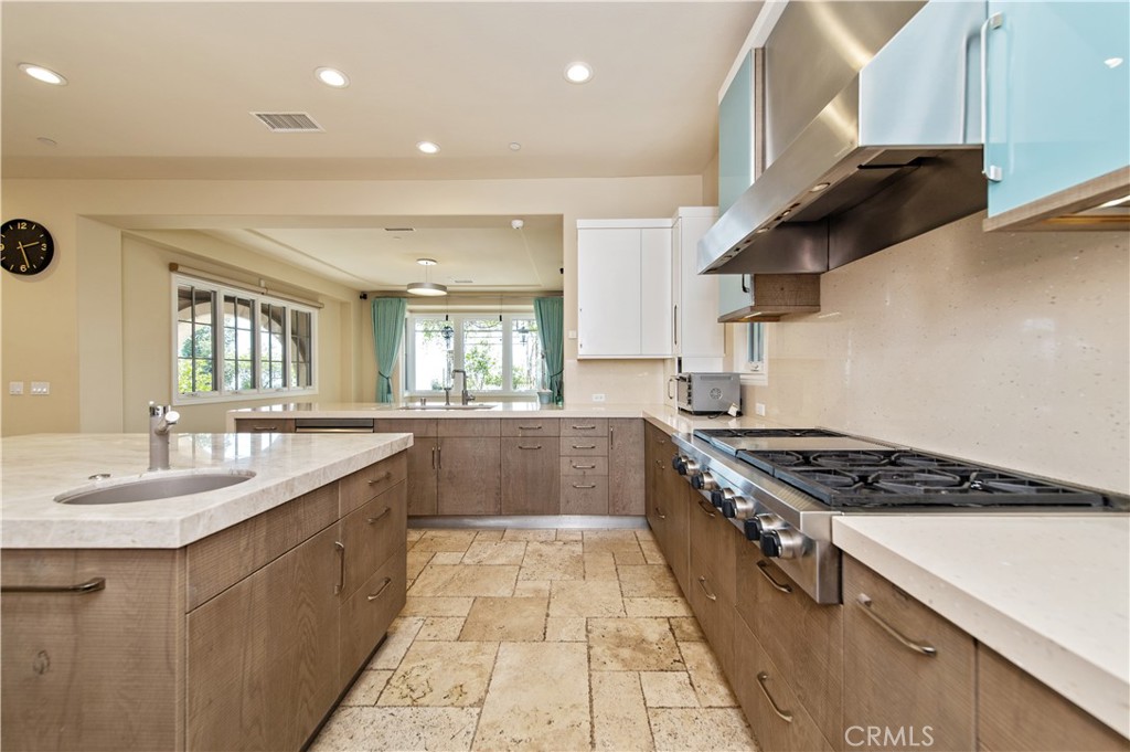 4 Starcatcher Newport Coast, CA 92657 - Photo 13 of 23 a kitchen with stainless steel appliances granite countertop a sink stove and cabinets