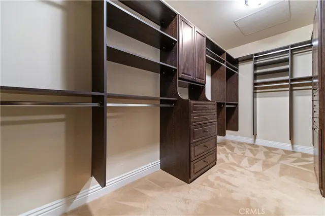 a utility room with stainless steel appliances white cabinets and a sink