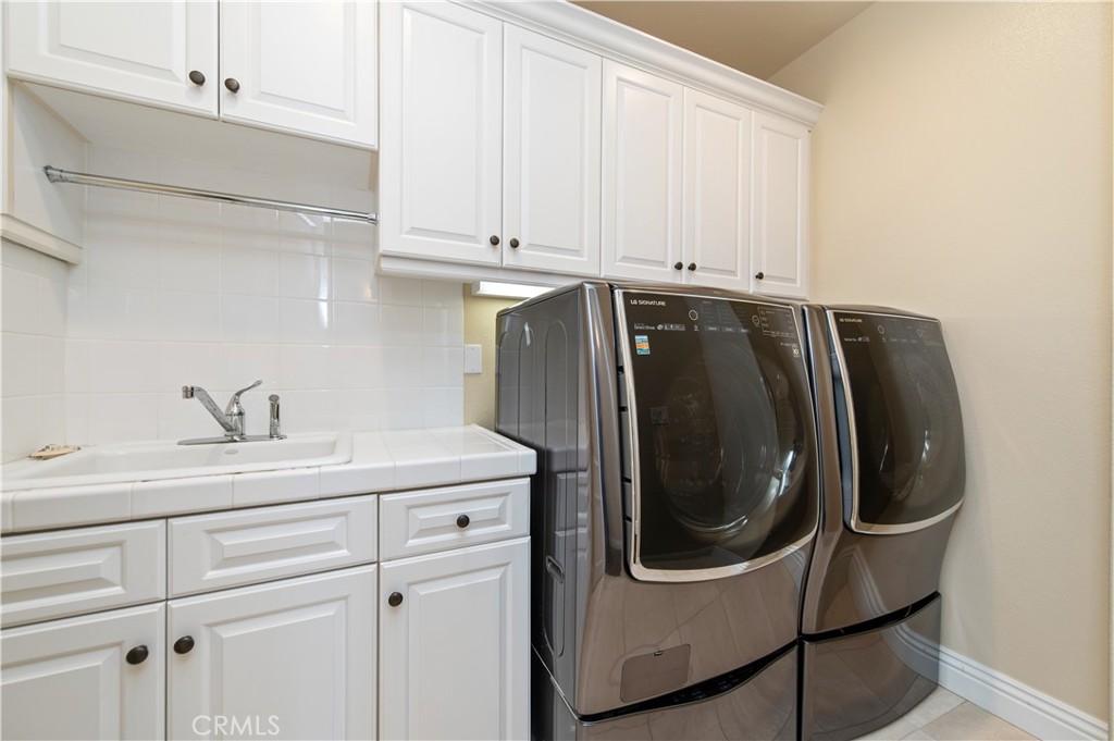 4 Starcatcher Newport Coast, CA 92657 - Photo 16 of 23 a utility room with stainless steel appliances white cabinets and a sink