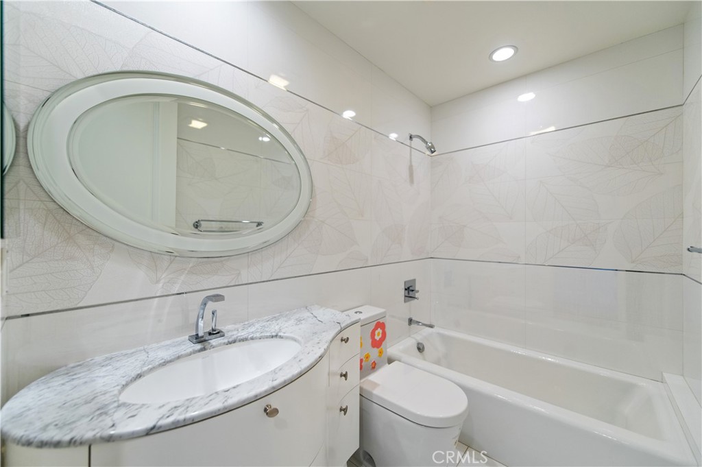 4 Starcatcher Newport Coast, CA 92657 - Photo 17 of 23 a bathroom with a granite countertop sink a toilet and bathtub