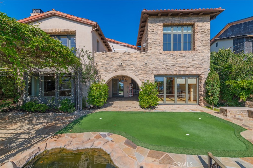 4 Starcatcher Newport Coast, CA 92657 - Photo 18 of 23 a front view of a house with a garden and yard