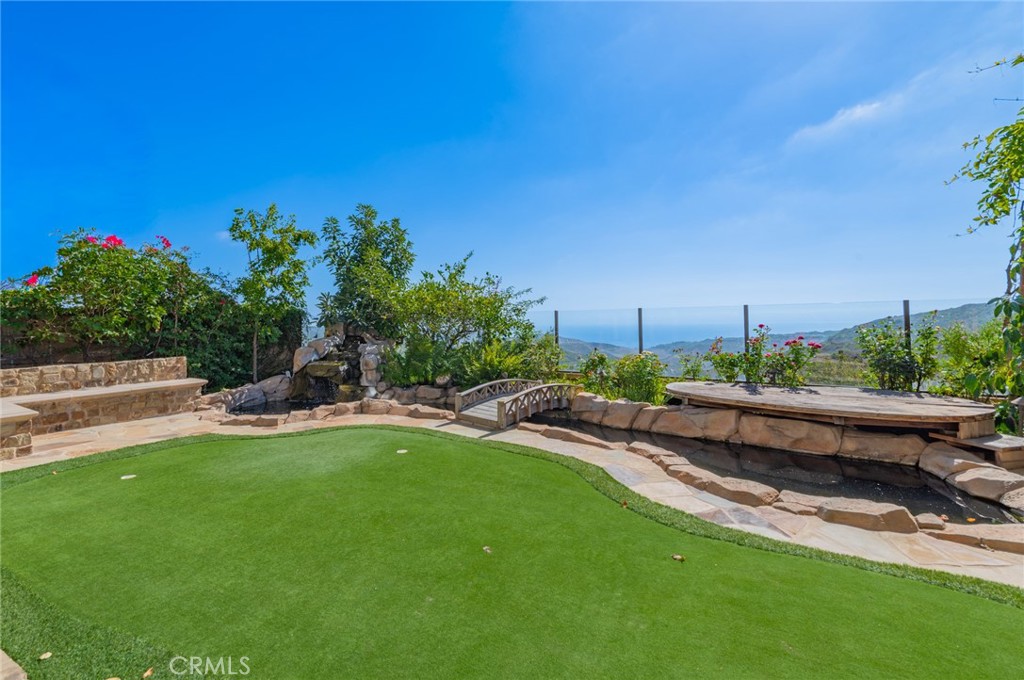 4 Starcatcher Newport Coast, CA 92657 - Photo 19 of 23 a view of a backyard with lawn chairs potted plants and a big yard
